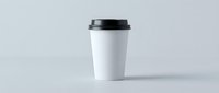 White disposable coffee cup with black lid on clean background for branding mockup and cafe marketing materials.