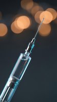 Medical syringe with needle against dark background with warm bokeh lights for healthcare and vaccination concepts.