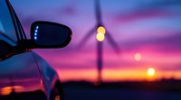 Blurred car side mirror and bokeh street lights against vibrant purple and orange sunset sky, creating dreamy atmospheric road trip scene at dusk.