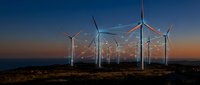 Wind turbines generating renewable energy at sunset with dramatic sky and rural landscape for sustainable power concepts.