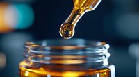 Golden drop of liquid medicine falling from glass dropper into amber bottle on dark background with bokeh lights, macro pharmaceutical photography.