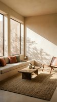 Modern minimalist living room with natural sunlight casting tree shadows through large windows creating warm ambiance for interior design and home decor.