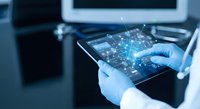 Healthcare professional using digital tablet with holographic network interface displaying connected data points and technological innovation in medical practice.