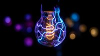 Glowing vintage Edison bulb with neon blue energy swirls on dark bokeh background, symbolizing creativity, innovation, and bright ideas.