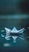 White paper boat floating on calm water surface with reflection creating peaceful minimalist composition for meditation and tranquility concepts.