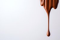 Dripping melted milk chocolate drop falling against white background, smooth glossy texture and flowing liquid form creates minimalist composition.