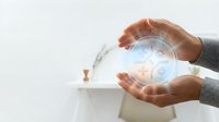Male hand holding glowing digital sphere with technology icons, representing innovation, data analysis, and business solutions for corporate and tech industry applications.