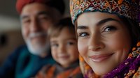 Multi-generational family portrait showing warm smiles and cultural attire with colorful headscarf and traditional clothing, expressing joy and connection in natural lighting.