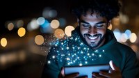 Young mixed-race man with curly hair smiling while opening glowing gift box with magical sparkles and bokeh lights in dark setting for holidays.