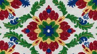 Vibrant floral mandala seamless pattern with red, blue, green and yellow ornamental motifs on light background for textile and wallpaper design.