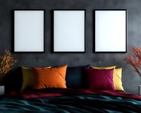 Modern bedroom interior with three blank white frames on dark gray wall, colorful orange and burgundy pillows, teal bedding and decorative dried plants.