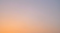 Serene gradient sky transitioning from soft peach and golden tones to cool lavender and gray hues, evoking peaceful dawn or dusk atmosphere for backgrounds and design projects.