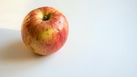 Fresh red and yellow apple on white background isolated for healthy eating concepts and organic food marketing materials.