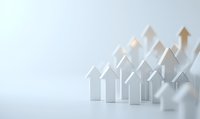 White paper houses arranged in ascending order with upward arrows showing growth trend on light background, representing real estate market progress.