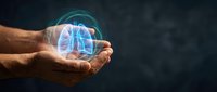 Male hands holding glowing holographic lungs with protective shield symbolizing respiratory health care and medical protection technology.