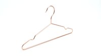 Rose gold wire clothes hanger isolated on white background, minimalist wardrobe accessory for fashion, retail, and home organization concepts.