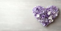 Purple floral heart arrangement made of hydrangea and rose petals on light gray background with copy space. Romantic wedding or Valentine concept.