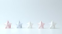 Minimalist paper origami stars in soft pastel pink and white colors arranged in row on white background, creating clean geometric composition for modern design projects.
