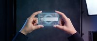 Businessman hands holding transparent futuristic holographic interface with digital data visualization and analytics dashboard for modern technology presentation.