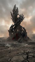 Massive dark crystalline structure rising from barren wasteland with dramatic cloudy sky, featuring jagged spires and red accents for sci-fi, fantasy, and gaming concepts.