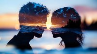 Double exposure silhouette of young couple facing each other combined with sunset ocean view, waves and rocky coast creating romantic atmospheric composition.