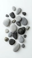 Collection of smooth and rough natural stones in various sizes isolated on white background for spa wellness and meditation concepts.