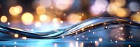 Flowing water wave with golden bokeh lights creating magical atmosphere. Abstract liquid motion with sparkles and reflections against blurred background.