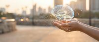 Hand holding glowing brain with neural connections against urban skyline at sunset, representing innovation, artificial intelligence, and creative thinking for business solutions.