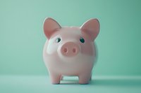 Pink ceramic piggy bank on mint green background, symbolizing savings, financial planning, and money management for personal budgeting.