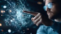 Young Asian male professional interacting with glowing digital network visualization, pointing finger at floating holographic interface against dark background with bokeh effects.