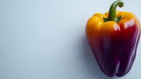 Fresh bell pepper with gradient color from yellow to deep purple on light background, organic produce with vibrant hues and smooth texture for food and cooking concepts.