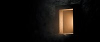 Open doorway with warm golden light glowing from inside a dark concrete tunnel or bunker, symbolizing hope, opportunity, escape, and new beginnings for business and personal growth concepts.