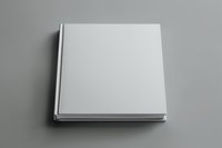 Blank white hardcover book mockup on gray background for branding and design presentation projects.