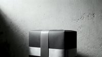 Elegant gift box wrapped with ribbon on concrete background, monochrome luxury present for holiday, birthday or corporate celebration.