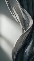 Flowing sheer fabric in monochromatic tones with dramatic light and shadow, creating elegant wave patterns suitable for backgrounds and design projects.