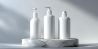White cosmetic bottles with pump dispensers on round marble platform against light gray background with soft shadows for beauty product mockup presentation.