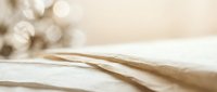 Open book with soft pages in warm beige tones creating peaceful reading atmosphere for education and literature concepts.