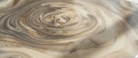 Swirling marble texture with soft beige, cream, and brown tones creating an elegant abstract fluid pattern for luxury backgrounds and design.