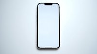 Modern black smartphone with blank white screen mockup on light gray background for app presentation and digital design projects.