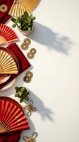 Chinese New Year celebration flat lay with red gold fans, lucky coins, jade plants and traditional decorations on white background for festive design.