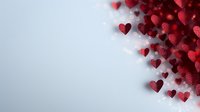 Red glittery hearts scattered on light background creating romantic corner border design, love concept for Valentine's day cards and wedding invitations.