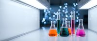 Laboratory glassware with colorful chemical solutions in modern research facility with bokeh lights background for scientific experiments and analysis.