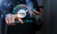 Businessman touching digital risk management dashboard with colorful gauge meter and analytics charts for financial assessment and business strategy.