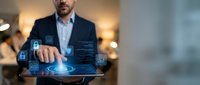 Professional businessman using digital tablet with holographic security interface displaying data analytics and cybersecurity icons in modern office environment.