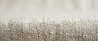 Natural burlap fabric texture with visible weave pattern and organic fibers creating rustic background surface for crafting and design projects.