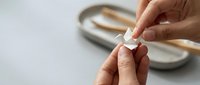 Young adult with medium skin tone breaking a cigarette in half as a gesture of quitting smoking and committing to health and wellness goals.