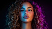 Young woman with curly hair in dramatic neon lighting against dark background, face illuminated by vibrant blue and pink colors creating modern artistic portrait with glowing effect.