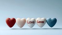 Five decorative hearts in red, white and blue colors arranged in row with love text on center hearts against light blue background. Romantic concept.
