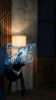 Businessman hand touching holographic digital interface displaying financial charts and analytics data in modern office environment.