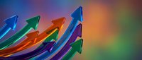 Colorful glass arrows pointing upward on gradient background representing growth, success, progress and business development concepts for presentations.